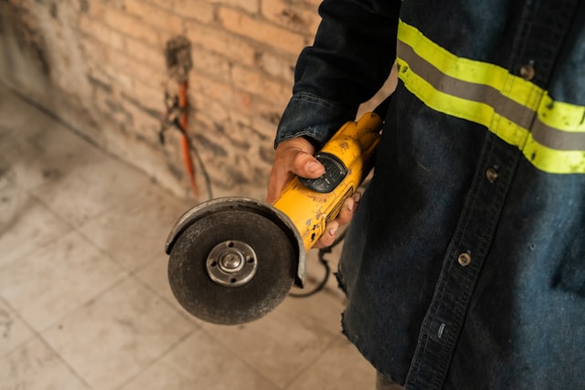 tradie holding a grinder